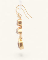 Single triple Herkimer quartz gold-plated drop earring in side profile, showing three stacked bezel-set raw crystal stones