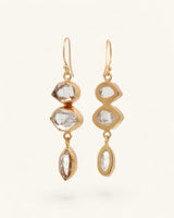 Triple Herkimer quartz gold-plated drop earrings at an angle, showing gold bezel back structure and varied stone settings
