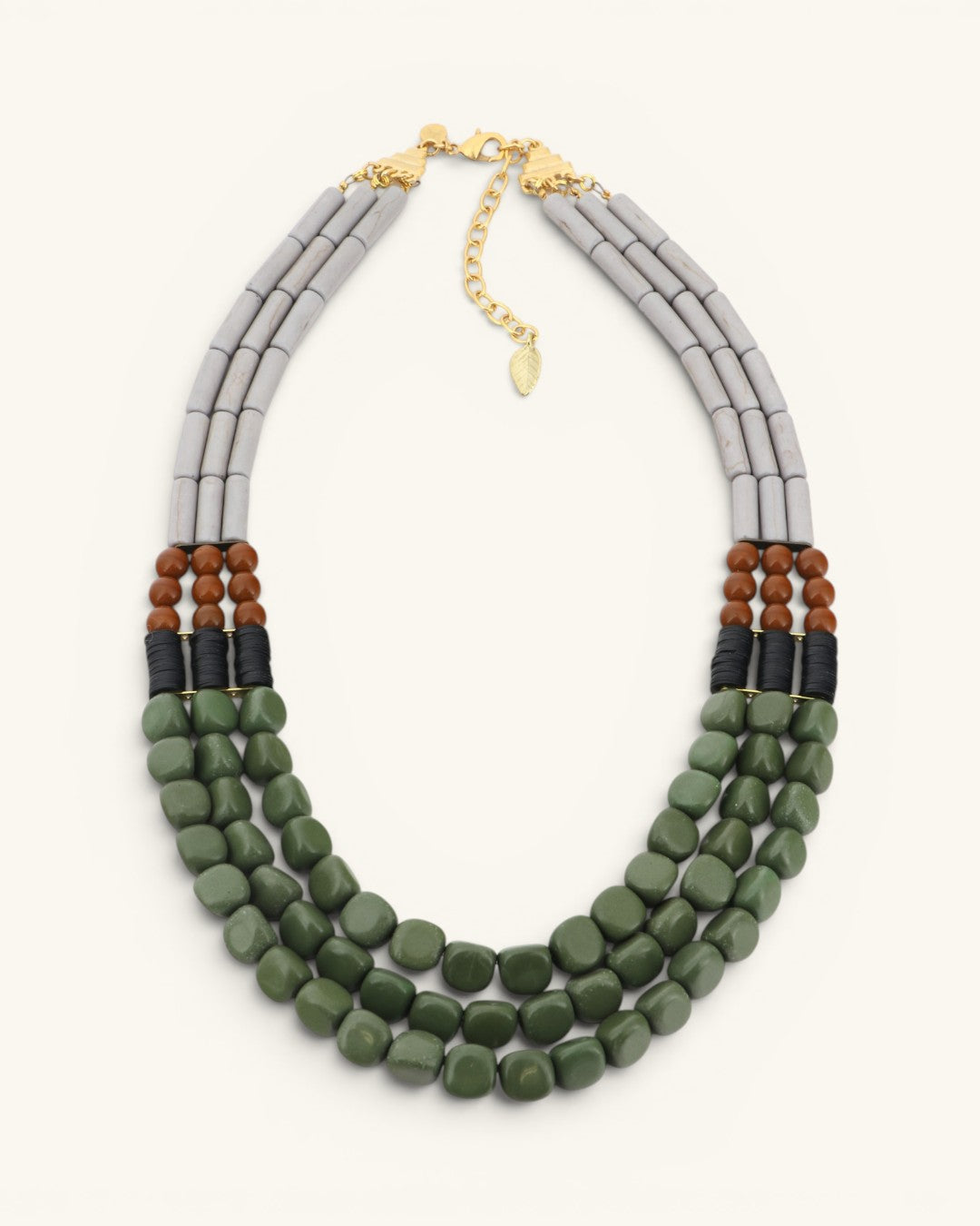 Triple strand magnesite, serpentine and vulcanite beaded necklace shown upright and centered, full front view on white background