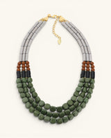 Triple strand magnesite, serpentine and vulcanite beaded necklace shown upright and centered, full front view on white background