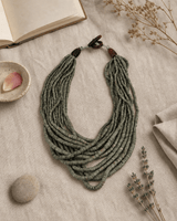 Layered Coconut Bead Necklace in Neutral Tones — necklaces, flatlay linen lifestyle photo