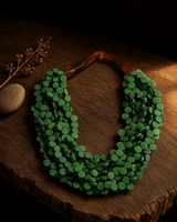 Twisted green wood disc pendant necklace with rim lighting highlight, handcrafted statement jewelry