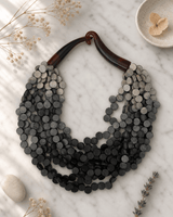 Twisted Multi-Strand Grey Ombre Wooden Disc Necklace — necklaces, editorial marble lifestyle photo