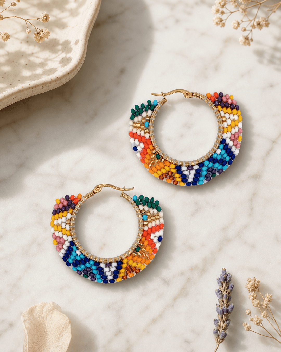 Vibrant Vista Handwoven Beaded Hoop Earrings — earrings, editorial marble lifestyle photo