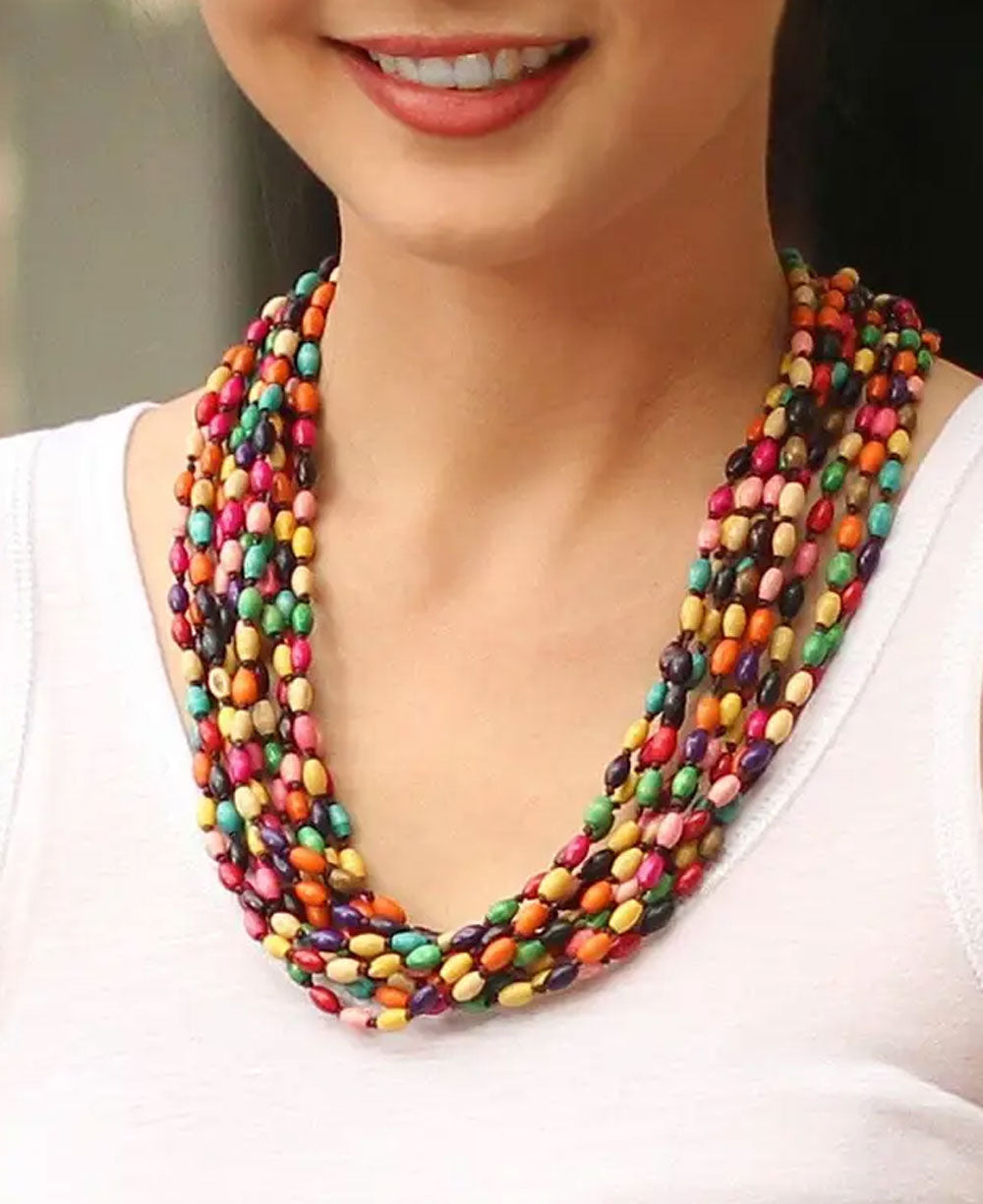 Smiling woman wearing a colorful necklace depicting multistrands